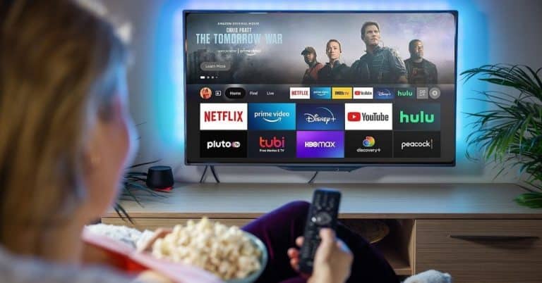 Person watching streaming apps on Smart TV using a Fire Stick device with Netflix, Disney+, YouTube, and Ilitha Internet